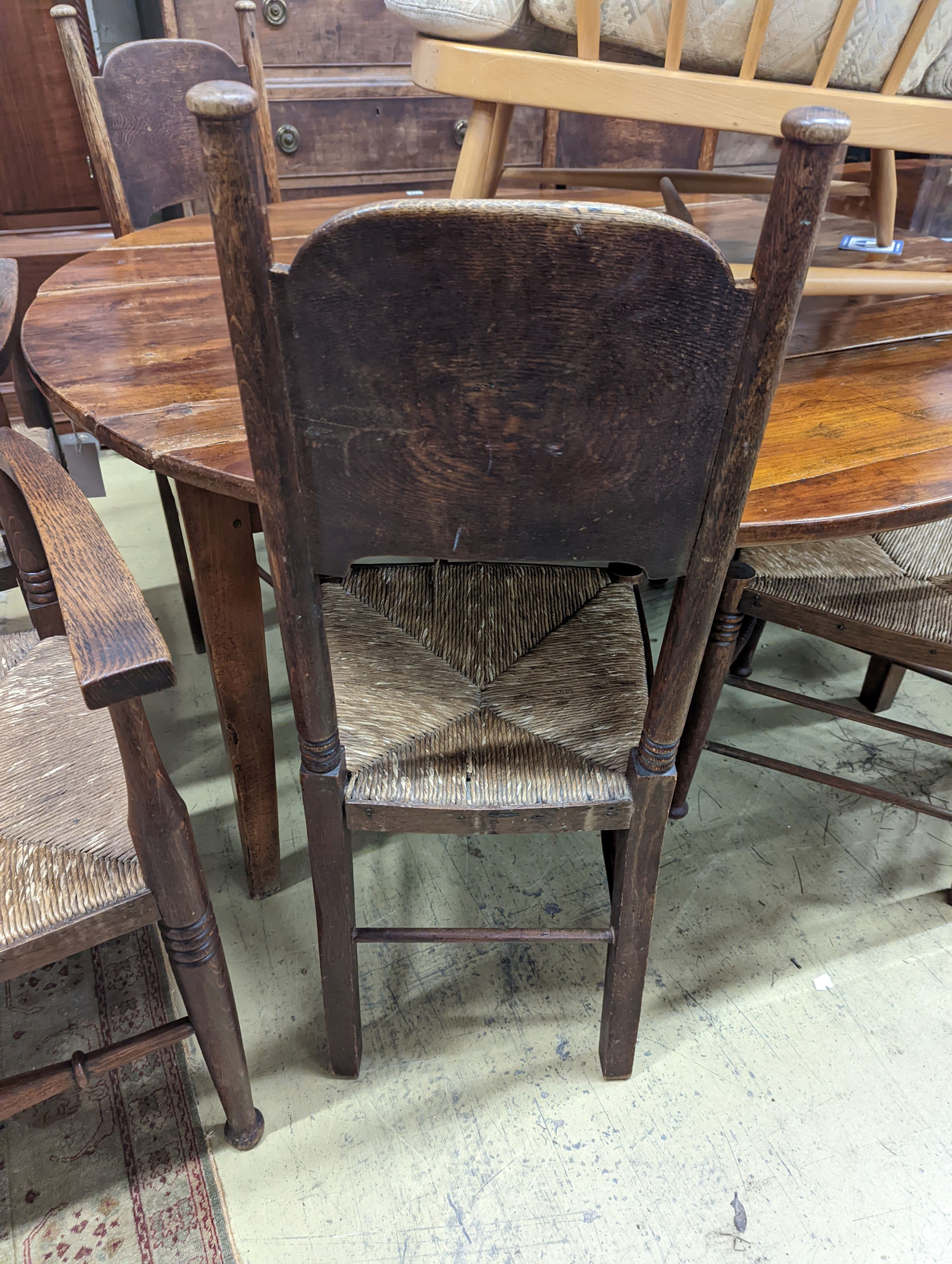A set of six Arts & Crafts oak chairs, including a pair of carvers, in the Glasgow School manner by William Birch, High Wycombe, carvers W.58cm D.54cm H.109cm